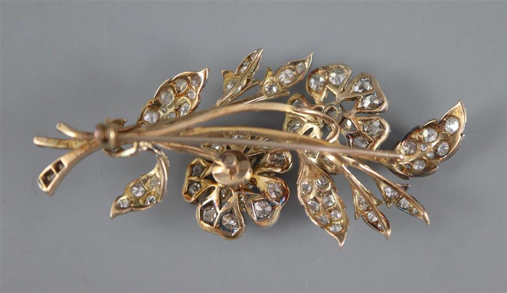 A Victorian gold, silver and graduated old round and cushion cut diamond set trembleuse floral spray brooch,